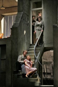 Mimi and Rodolfo, with Musetta at top of stairs. Photo by Ken Howard.