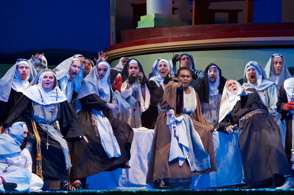 Barry Banks (Count Ory) and Will Liverman (Raimbaud) with members of the Seattle Opera chorus. Jacob Lucas photo